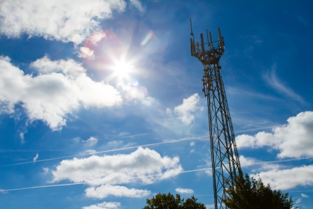 Mobile phone mast with a blue sky behindの写真素材