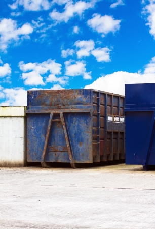 recycling centre waste bin with a cloudy blue  skyの写真素材