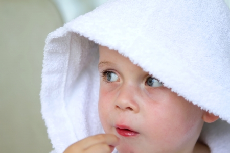 little boy wearing a white bath robeの写真素材