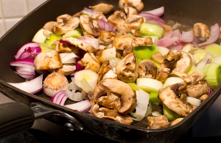 Mushrooms, Leeks and red onions frying in a panの写真素材