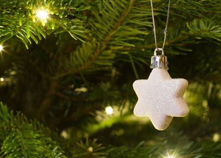 christmas star hanging on the christmas treeの写真素材