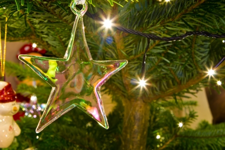 christmas star hanging on the christmas treeの写真素材