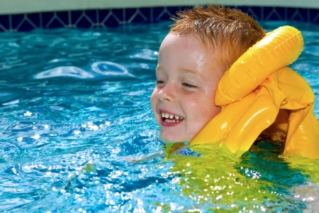 little boy swimming with life vest onの写真素材