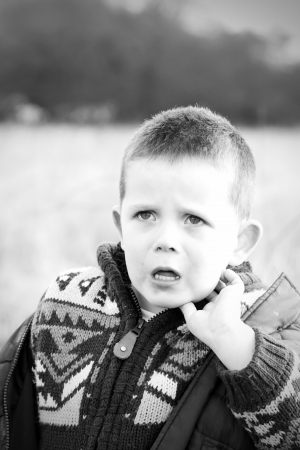 sad little boy in the countrysideの写真素材