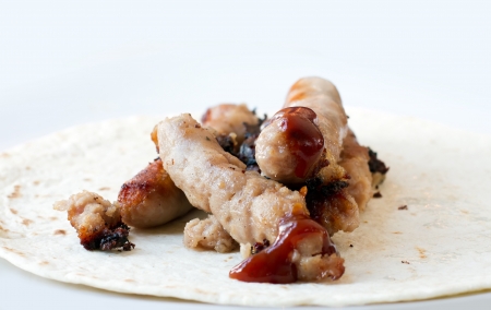 sausages in a tortilla wrap with tomato sauceの写真素材