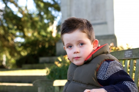 young boy staring ahead with emotion on faceの写真素材