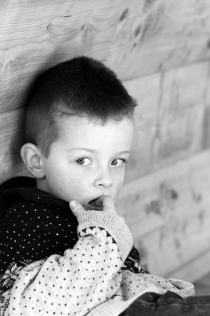 Depressed young boy looking directly aheadの写真素材