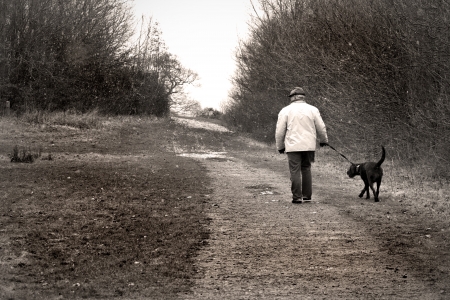 old man walking the dogの写真素材