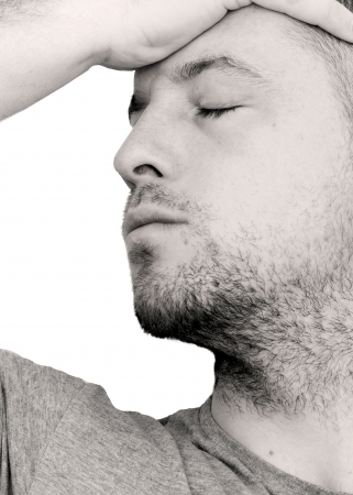 depressed man with head in his handsの写真素材