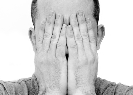 depressed man with head in his handsの写真素材