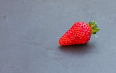  strawberry on a black slate tileの写真素材