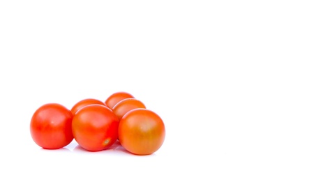 cherry tomatos grouped together on whiteの写真素材