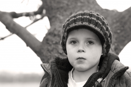 sad little boy staring aheadの写真素材