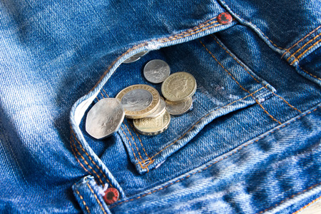 UK coins falling out of jeans pocketの写真素材