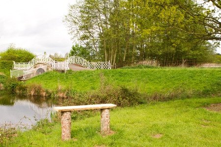 peaceful nature area with river and bridge in the English countrysideの写真素材