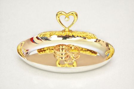 Two golden wedding rings on the white background.の写真素材