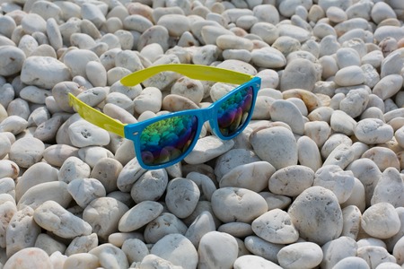 Mirror sun glasse on the white stonesの写真素材