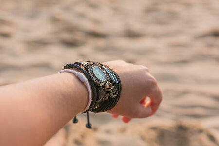 Woman s wrist with watch and bracelets の写真素材