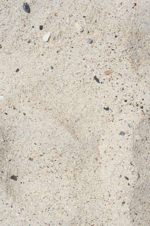 White sand and small stones texture and backgroundの写真素材