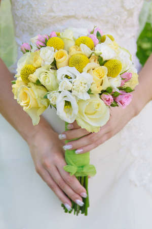 Beautiful wedding bouquet in hands of the brideの写真素材