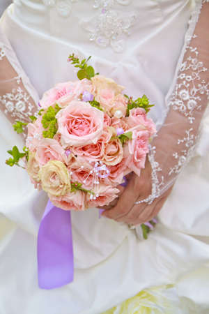 Beautiful wedding bouquet in hands of the brideの写真素材