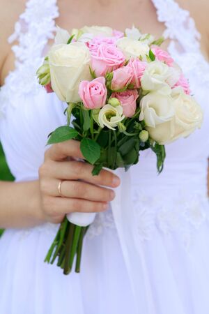 Bride is holding beautiful bright wedding bouquetの写真素材