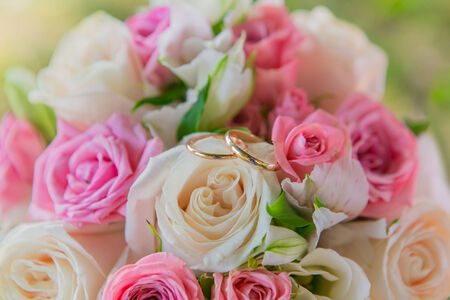 Beautiful wedding bouquet and gold wedding ringsの写真素材