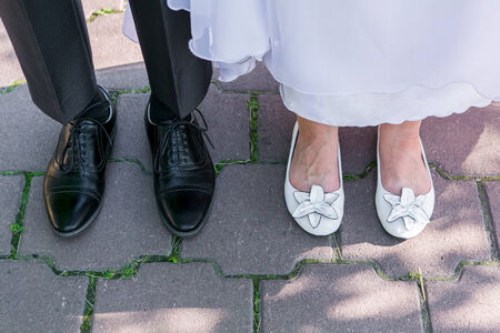 Feet of groom and bride standing close to each otherの写真素材