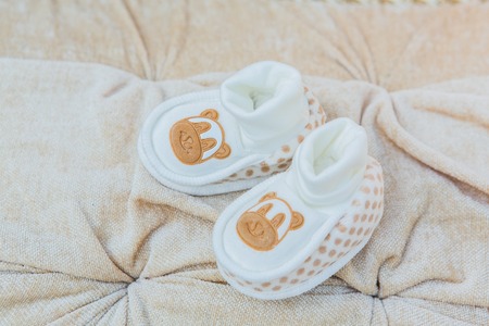 White baby's shoes on the cotton background.の写真素材