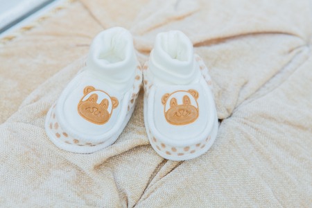 White baby's shoes on the cotton background.の写真素材
