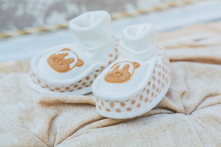 White baby's shoes on the cotton background.の写真素材