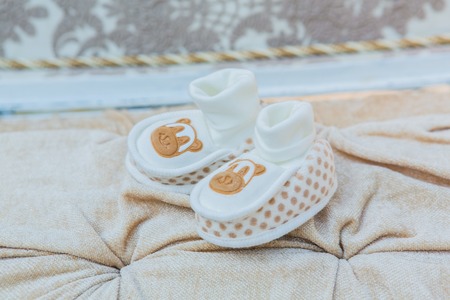 White baby's shoes on the cotton background.の写真素材
