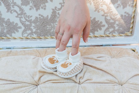 White baby's shoes on the cotton background.の写真素材
