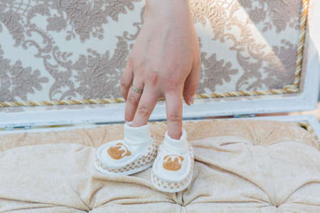 White baby's shoes on the cotton background.の写真素材