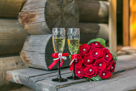 Wedding bouquete and glasses of champagne  on the woodの写真素材