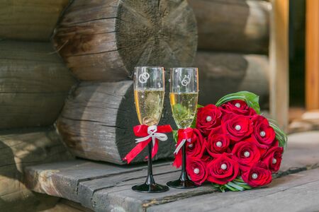 Wedding bouquete and glasses of champagne  on the woodの写真素材