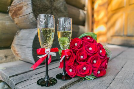 Wedding bouquete and glasses of champagne  on the woodの写真素材
