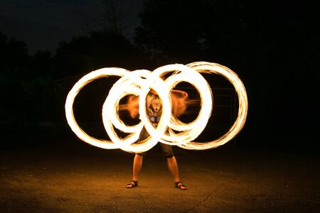 Fire-show man in action in night time.