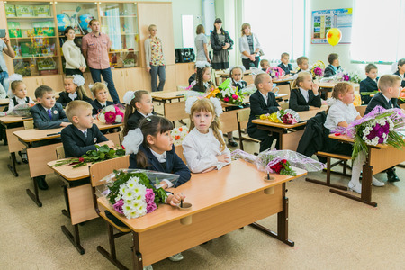 NOVOKUZNETSK, KEMEROVO REGION, RUSSIA - SEP, 1, 2014: First-grade students and teacher are in school classroom at first lesson. The day of knowledge in Russia.のeditorial素材