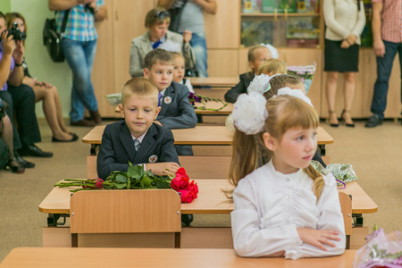 NOVOKUZNETSK, KEMEROVO REGION, RUSSIA - SEP, 1, 2014: First-grade students and teacher are in school classroom at first lesson. The day of knowledge in Russia.のeditorial素材