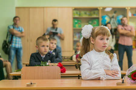 NOVOKUZNETSK, KEMEROVO REGION, RUSSIA - SEP, 1, 2014: First-grade students and teacher are in school classroom at first lesson. The day of knowledge in Russia.のeditorial素材