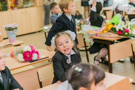 NOVOKUZNETSK, KEMEROVO REGION, RUSSIA - SEP, 1, 2014: First-grade students and teacher are in school classroom at first lesson. The day of knowledge in Russia.のeditorial素材