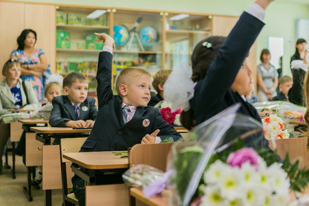 NOVOKUZNETSK, KEMEROVO REGION, RUSSIA - SEP, 1, 2014: First-grade students and teacher are in school classroom at first lesson. The day of knowledge in Russia.のeditorial素材