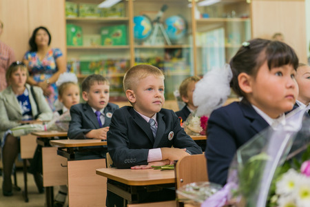 NOVOKUZNETSK, KEMEROVO REGION, RUSSIA - SEP, 1, 2014: First-grade students and teacher are in school classroom at first lesson. The day of knowledge in Russia.のeditorial素材