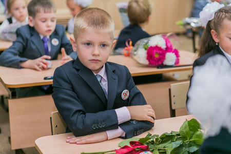 NOVOKUZNETSK, KEMEROVO REGION, RUSSIA - SEP, 1, 2014: First-grade students and teacher are in school classroom at first lesson. The day of knowledge in Russia.のeditorial素材