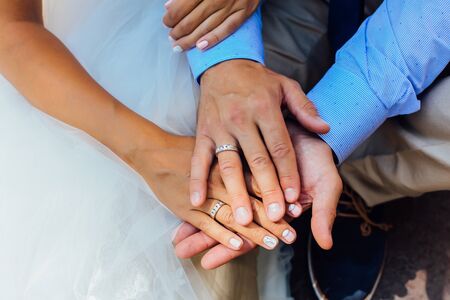 Hands of a man and a woman with wedding ringsの写真素材