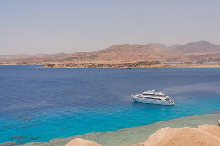 Egyptian beach with mountains and boat at Red seaの写真素材