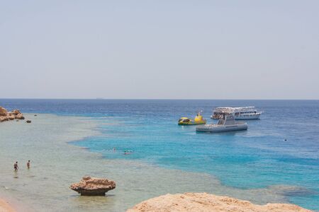 Sharm-El-Sheykh, Egypt - June 03, 2010 :: Egyptian beach with mountains and boat at Red seaのeditorial素材