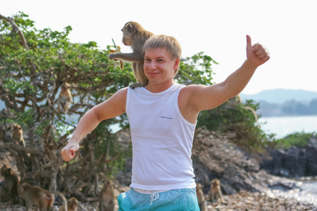 Monkey Island, Thailand - February 01, 2015 :: Caucasian tourists in Thailand on the Monkey Isaland with wild monkeys.のeditorial素材