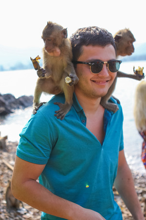 Monkey Island, Thailand - February 01, 2015 :: Caucasian tourists in Thailand on the Monkey Isaland with wild monkeys.のeditorial素材